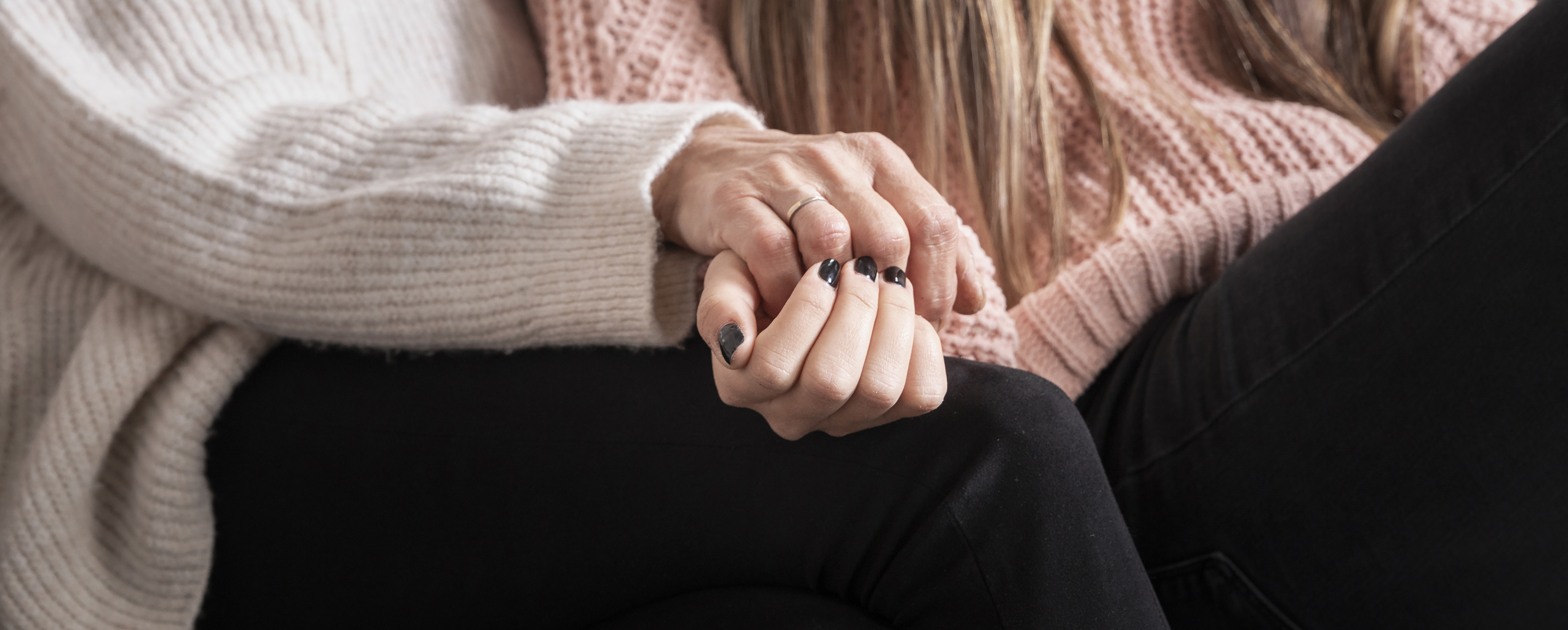Close-up of couple holding hands, seeking a sex therapist in San Francisco