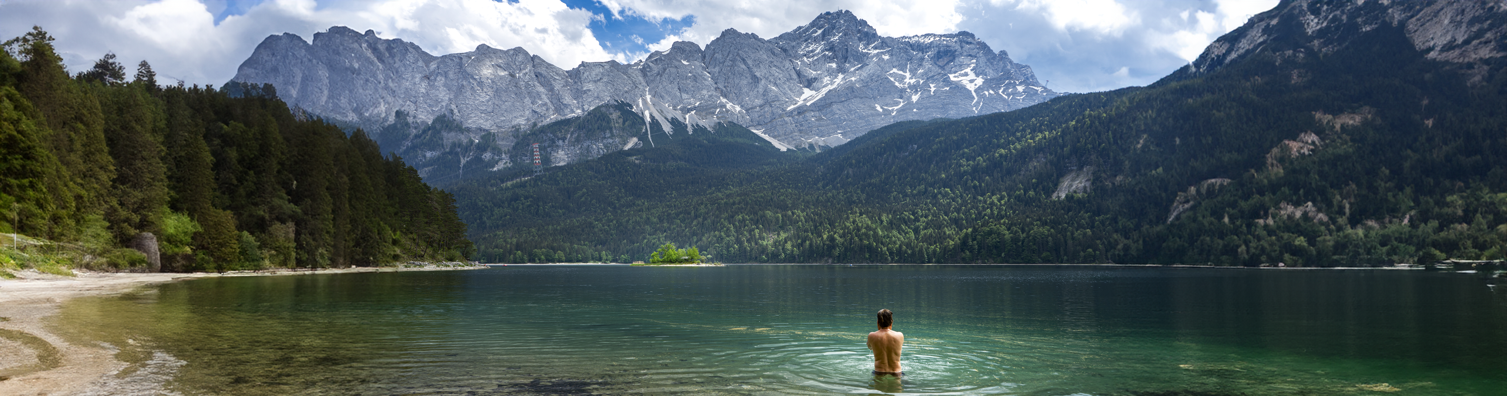 Blogs image: a person in a lake surrounded by mountains.